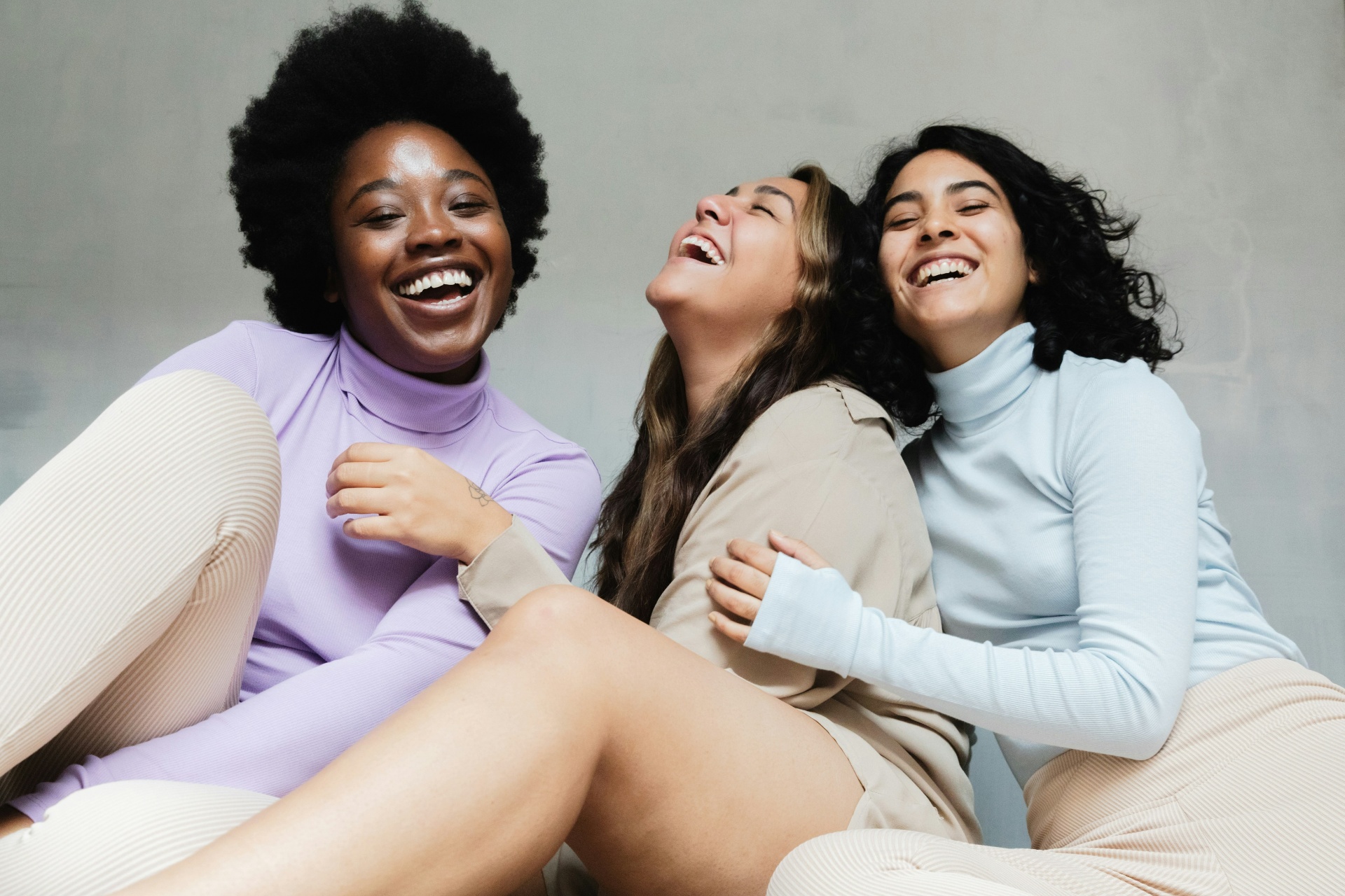 Three women laughing together